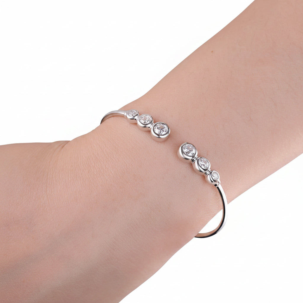 Silver bracelet with moissanite stones on a wrist against a white background