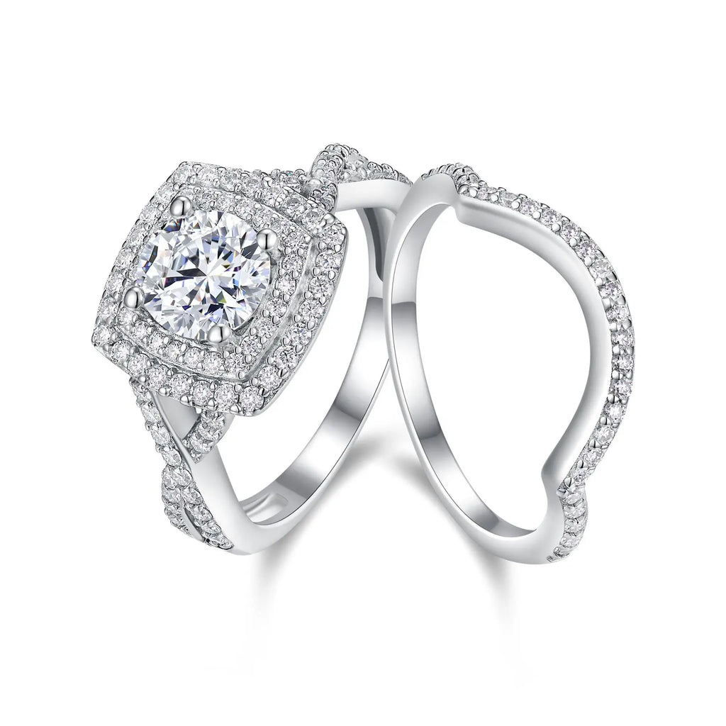 Silver ring with a large central moissanite gemstone and smaller stones on a white background