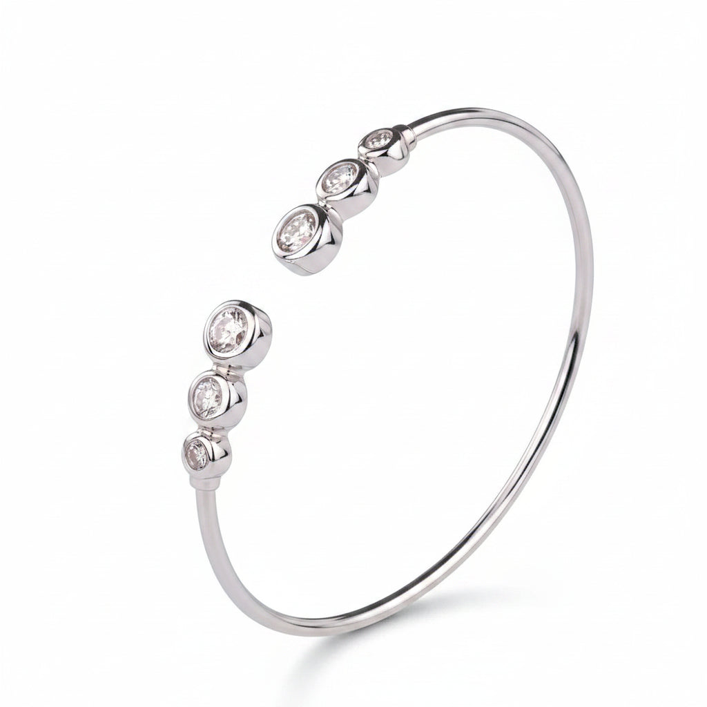 Silver bracelet with embedded diamonds on a white background