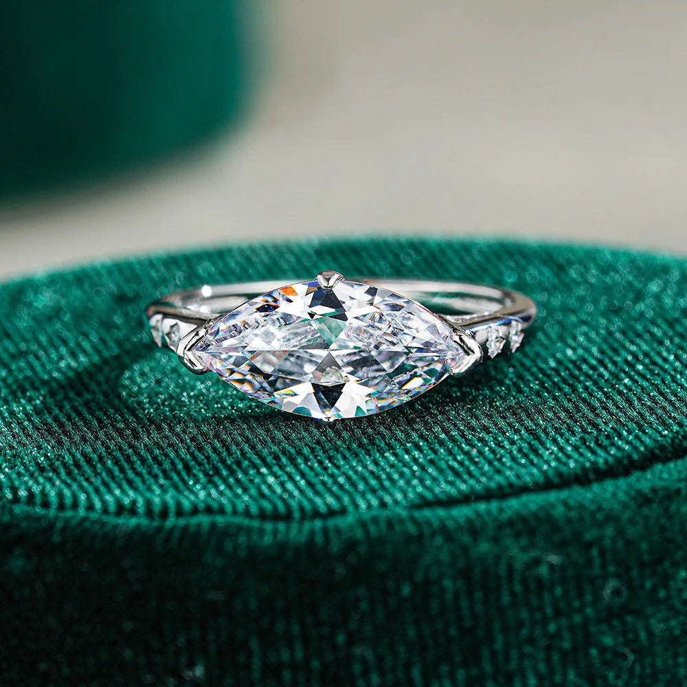 Moissanite ring on a green velvet cushion