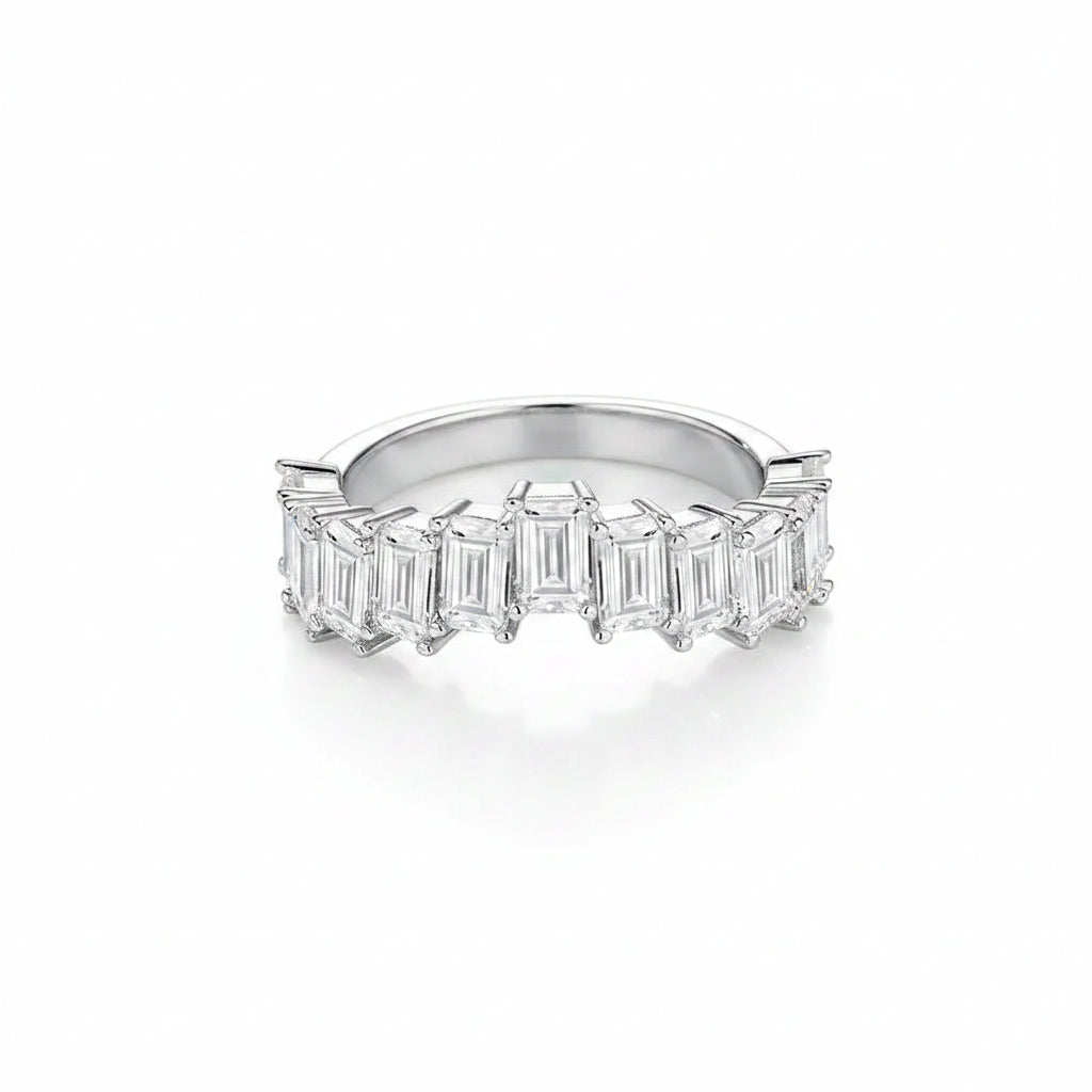 Moissanite ring with emerald-cut stones on a white background