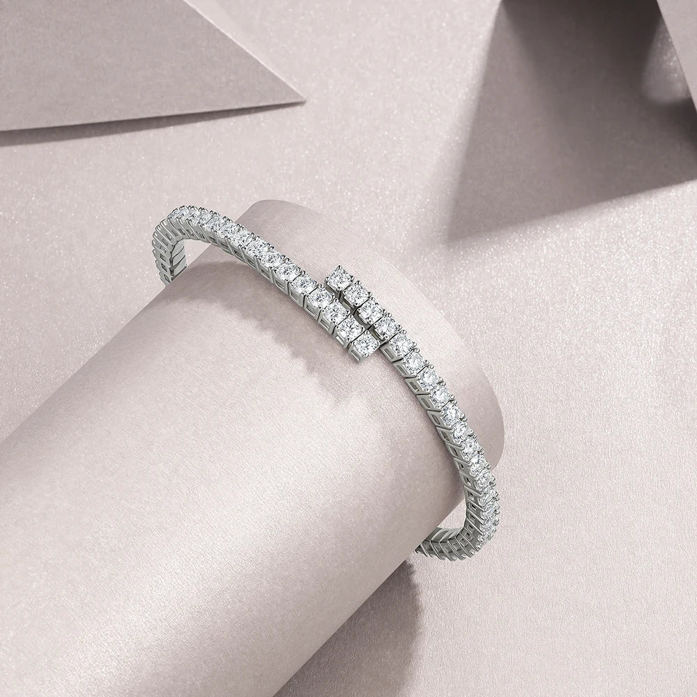 Moissanite silver bracelet with clear stones on a light pink surface